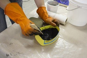 Mix grout with a common paint mixing stick.