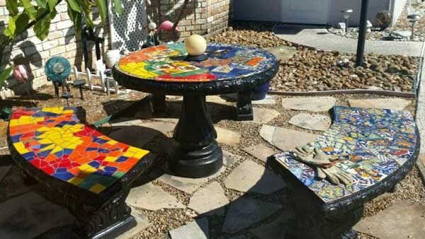 Outdoor Mosaic Patio Table with bench seats by Naomi Haas.