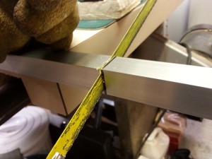 cutting the angle aluminum with a hacksaw