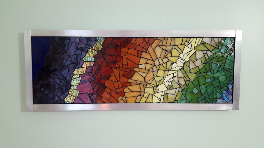 "Energy" mosaic art mounted on wall with french cleat.