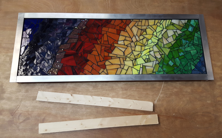 "Energy" mosaic art and two pieces of wood for french cleat wall mount system.