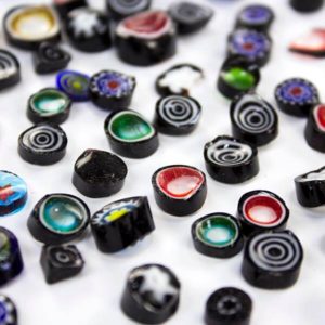 Black Rough Cut Millefiori with shards is cut to irregular thicknesses with some shards and slivers - an affordable product perfectly suited to glass fusing projects.
