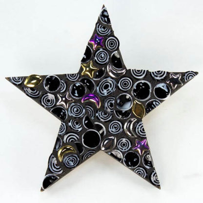 Mosaic on star shaped coaster base by Celia Favorite. Made with Rough Cut Millefiori and Ceramic Charms.