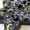 Mosaic on star shaped coaster base by Celia Favorite. Made with Rough Cut Millefiori and Ceramic Charms.